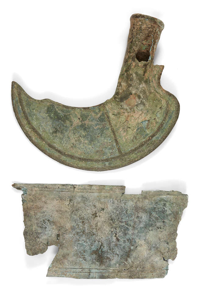 A bronze socketed sickle, Late Bronze Age, circa 1200-800 B.C., with hollow shaft, 18cm high and...