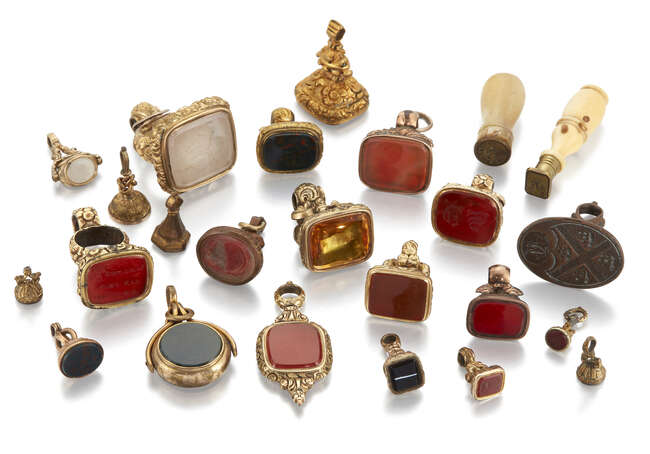 A group of twenty four 19th century fob and desk seals, including: a gilt metal swivel design...