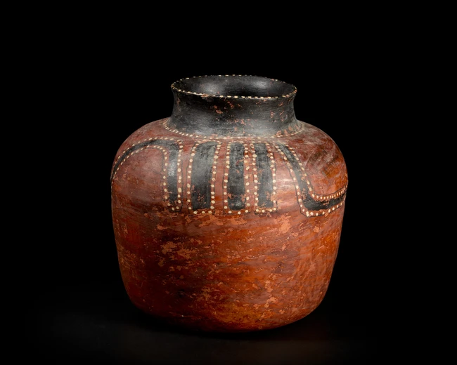 A Mayan red-slip glazed pottery vessel,Circa 2nd century AD,
22.5cm. high
Provenance: Property...