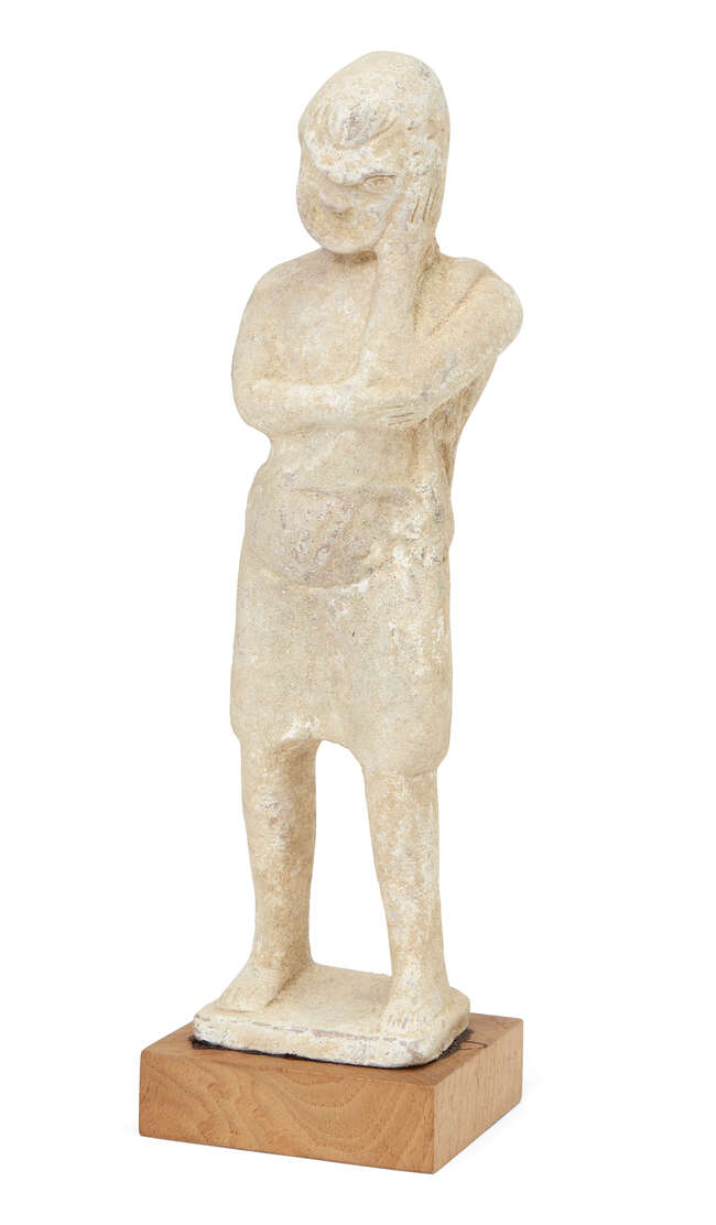 
	
		A hollow terracotta standing theatrical figure wearing the mask of a comic actor, resting...