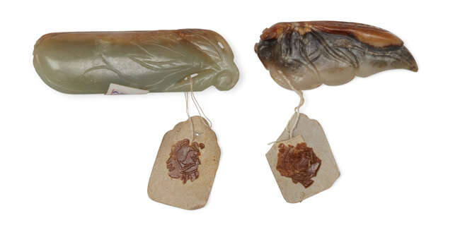 
	
		Two Chinese jade pendants, early 20th century, one of celadon and russet tone carved as a...