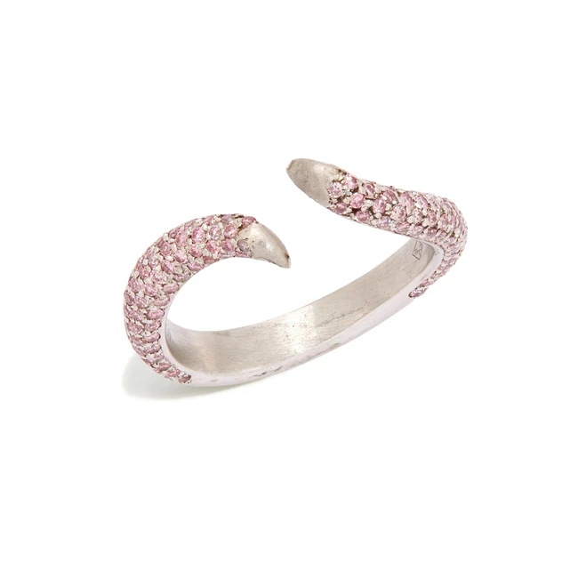 A pink diamond set torque ring, the tapering crossover shoulders pavé set with brilliant-cut...