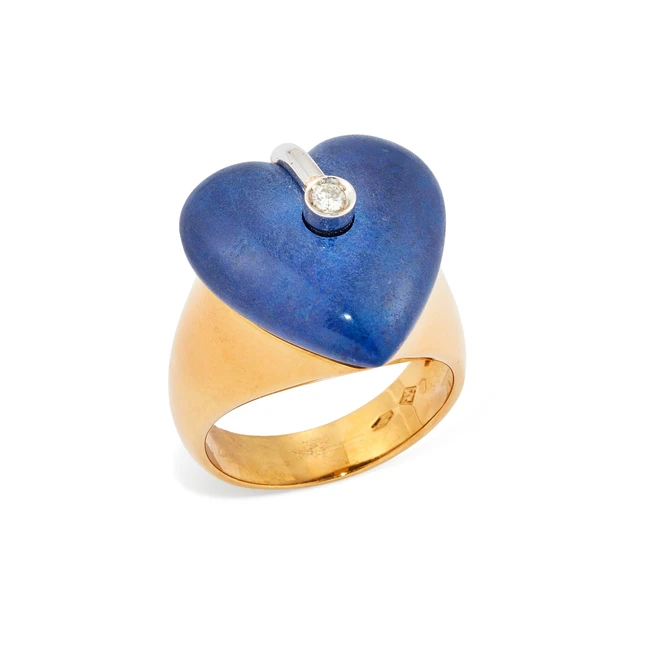 A diamond set heart shaped ring, the head with a brilliant cut diamond bezel set to a carved,...