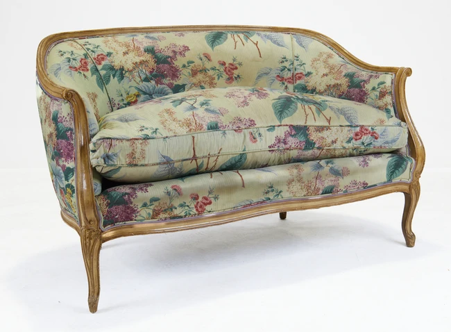 A French beech canapé, of Louis XV style, third quarter 20th century, with curved back, and...