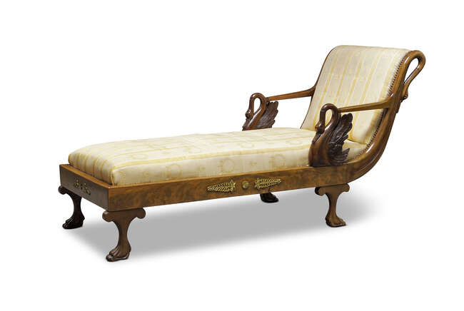
	
		An Empire style chaise longue, late 19th century and later, the curved backrest flanked...