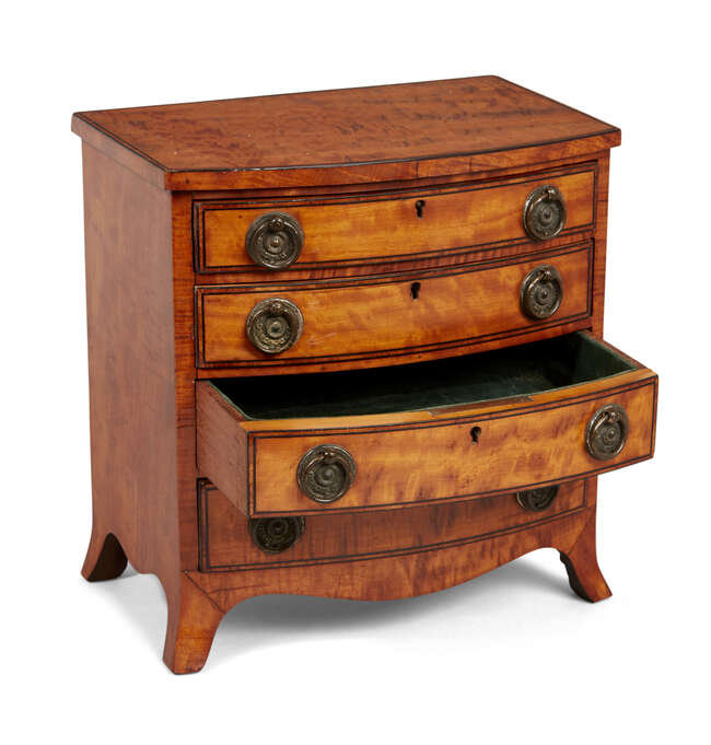 
	
		A Regency satinwood miniature bow-fronted chest, the four long drawers inlaid with ebony...