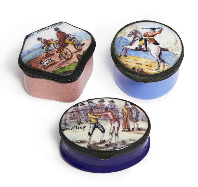 
	
		Three English enamel patch boxes, 19th century,  one entitled Wrestling, one with Samson...