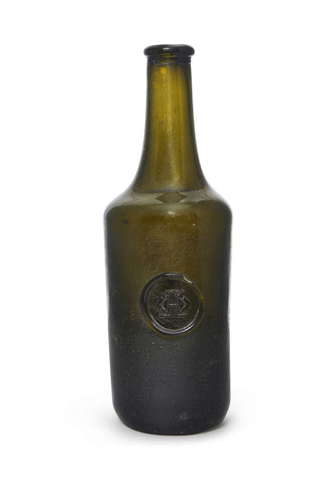 
	
		A pale green glass sealed wine bottle, 18th century, with long neck, with a circular seal...