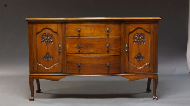 
	
		An Edwardian cherry wood sideboard, the shaped top above three drawers, flanked by two...