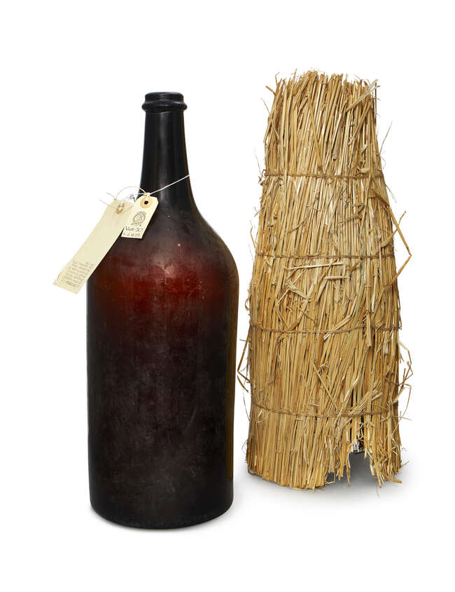 
	
		A French brown glass Methuselah Champagne bottle, late 19th century, with a straw...