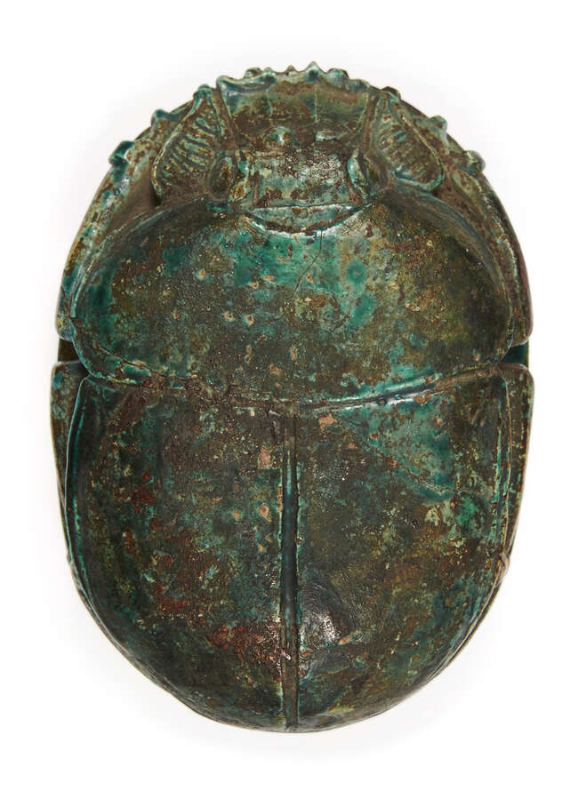 
	
		An Egyptian revival ware green-glazed stone scarab, 19th century, inscribed with 10 lines...