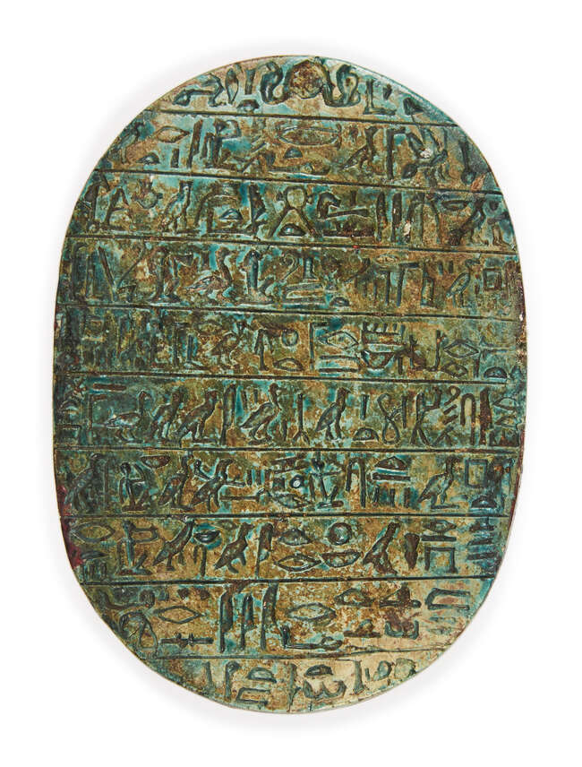 
	
		An Egyptian revival ware green-glazed stone scarab, 19th century, inscribed with 10 lines...
