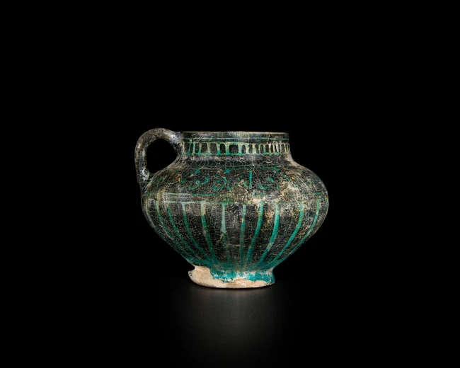 A globular black and turquoise blue glazed pottery pouring vessel, Ilkhanid central Iran,...