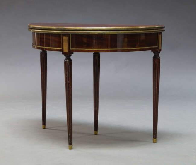 
	
		A Louis XVI style mahogany and brass mounted demi lune card table, late 19th, early 20th...
