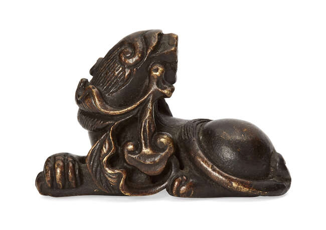 
	
		A Chinese bronze lion dog scroll weight, Ming dynasty, 17th century, modelled in...