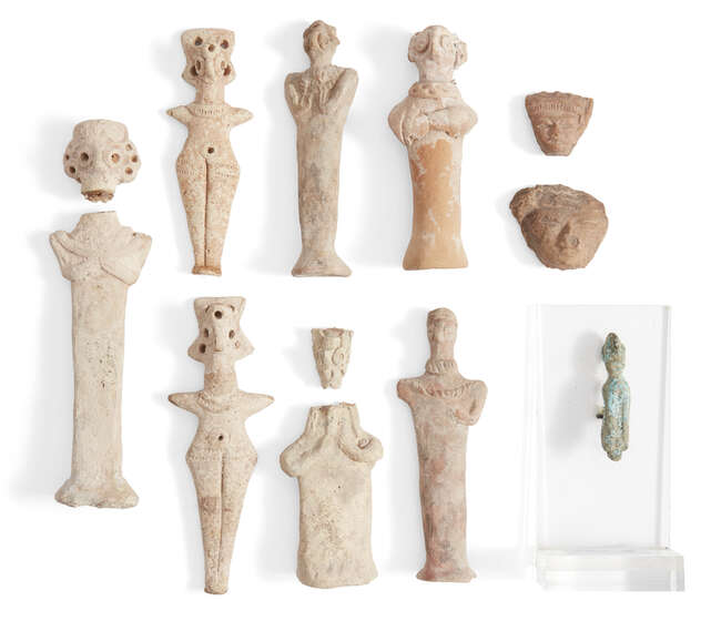 
	
		Two Syrian terracotta Astarte figures, with peg-shaped legs, incised girdle and applied...