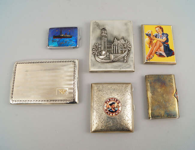 
	
		A silver cigarette case, with later applied Player&#39;s Navy Cut circular plaque, a further...