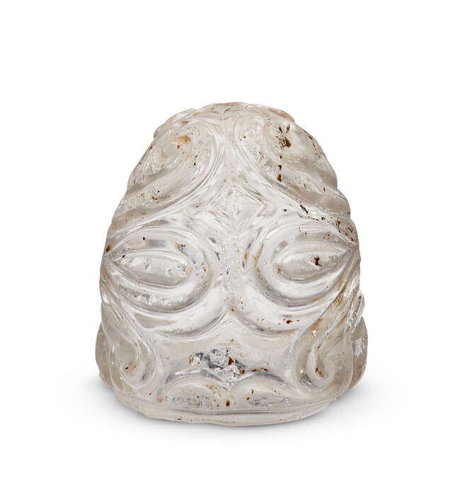 
	
		An Abbasid or Fatimid carved rock crystal chess piece, 9th-11th century, carved with deep...