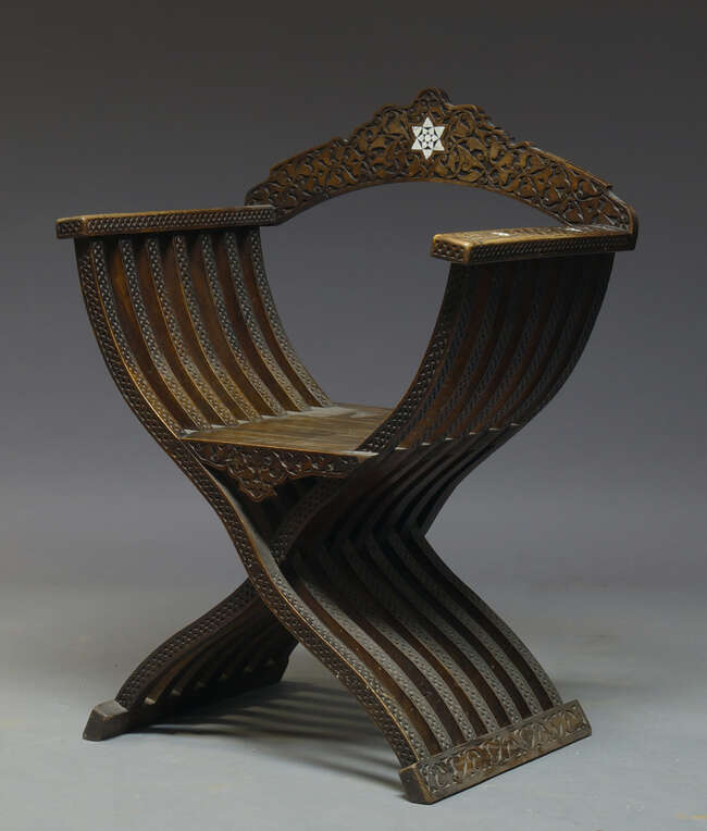 
	
		A hardwood and mother of pearl inlaid Savonarola chair, first half 20th Century, with...