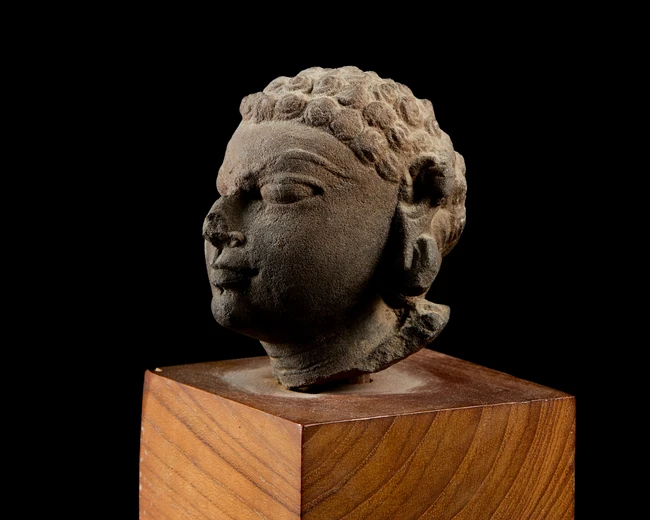 A fragmentary sandstone head, India, Gupta period, circa 4th century, 
with bulging almond...