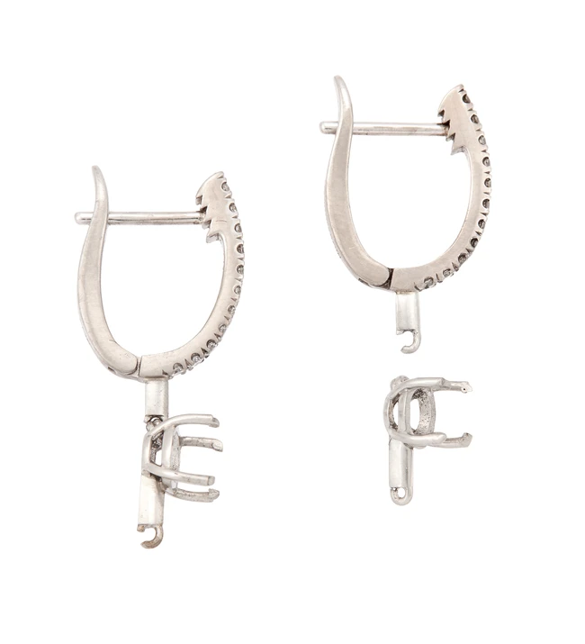 A pair of 18ct white gold diamond set earring mounts with vacant collets, designed as a...