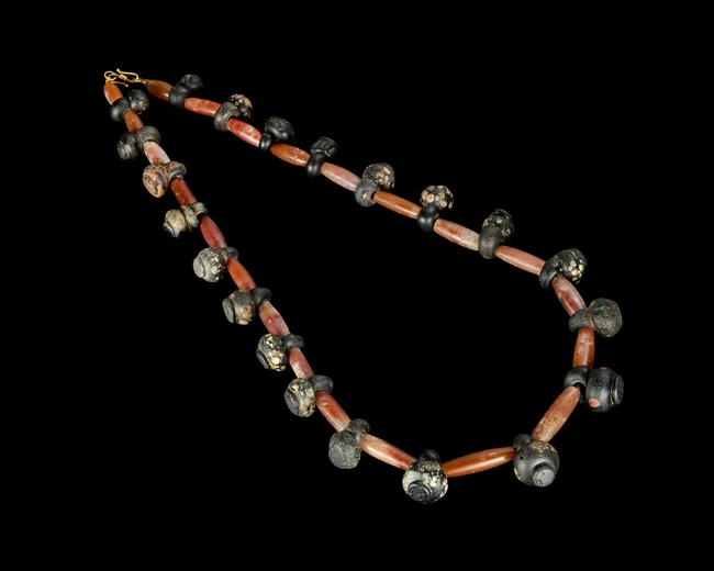 A glass bead and carnelian necklace,Probably late Roman circa late 6th-4th century ADComposed of...