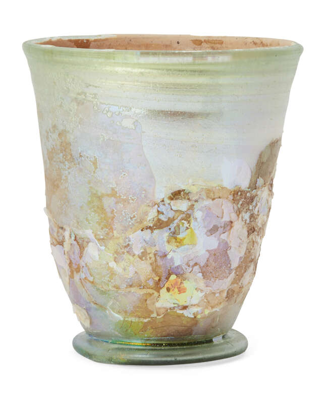 A Roman pale green glass beaker on a folded ring base, with wheel-abraded bands below the rim,...