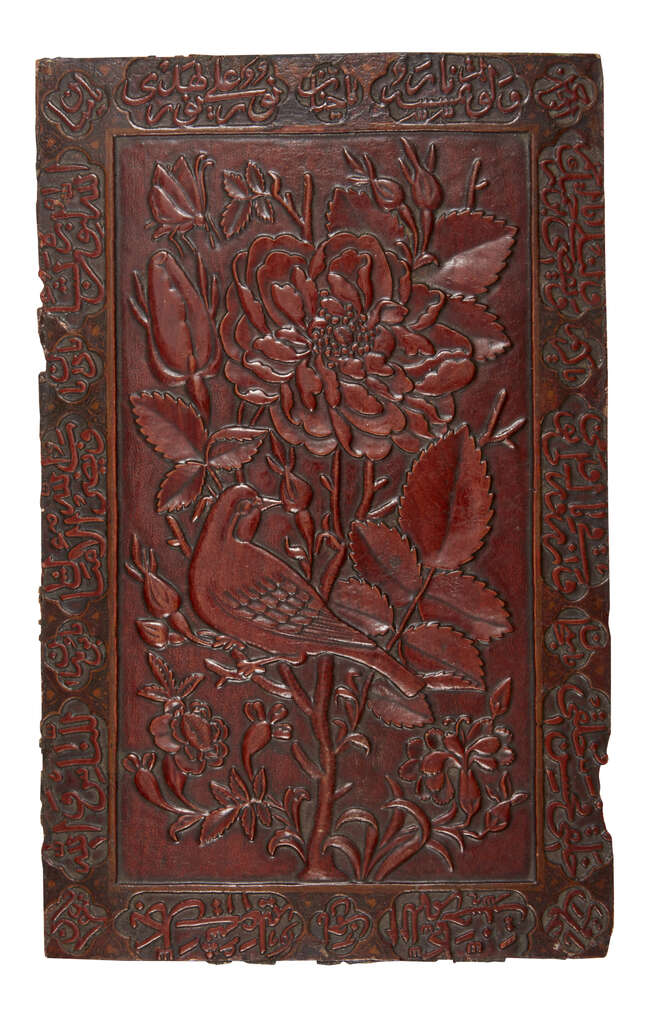 
	
		A Qajar carved wood book cover, Iran, 19th century, with gul-o-bulbul design surrounded...