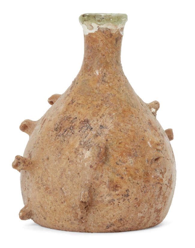 
	
		A Roman bottle with pinched projections, Eastern Mediterranean, circa 5th-6th century...