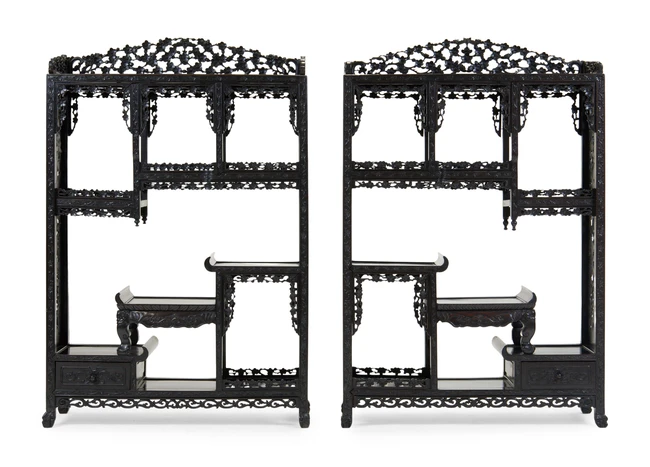 A pair of Chinese hongmu display stands, last quarter 19th century, profusely carved with...