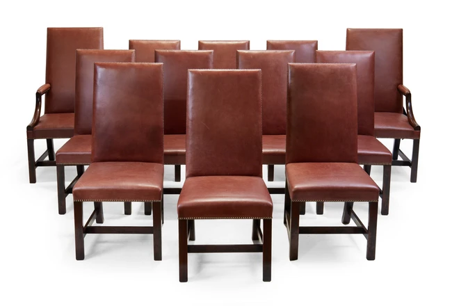 A set of twelve modern mahogany dining chairs, of George III style, with burgundy faux leather...