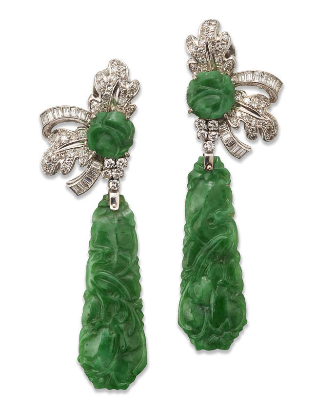 
	
		A pair of Jadeite jade and diamond pendant earrings, each designed as a  claw-set carved...