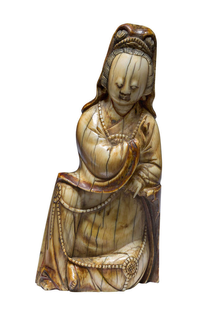 
	
		A Chinese ivory figure of Guanyin, Ming dynasty, 16th century, carved seated, wearing...