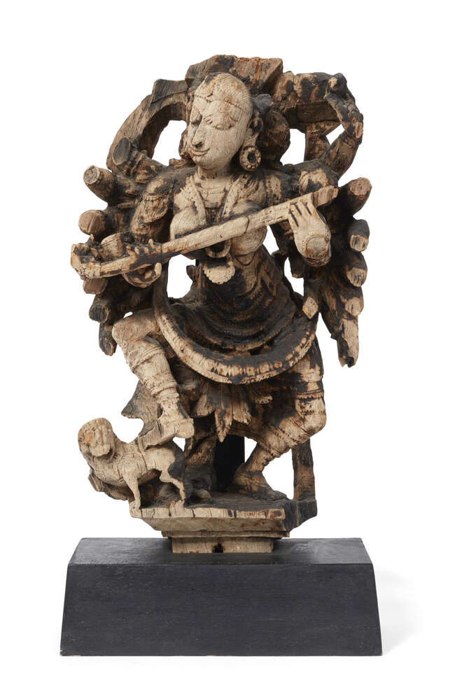 A Indonesian carved and pierced wood sculpture of a lady, probably an architectural fragment, 