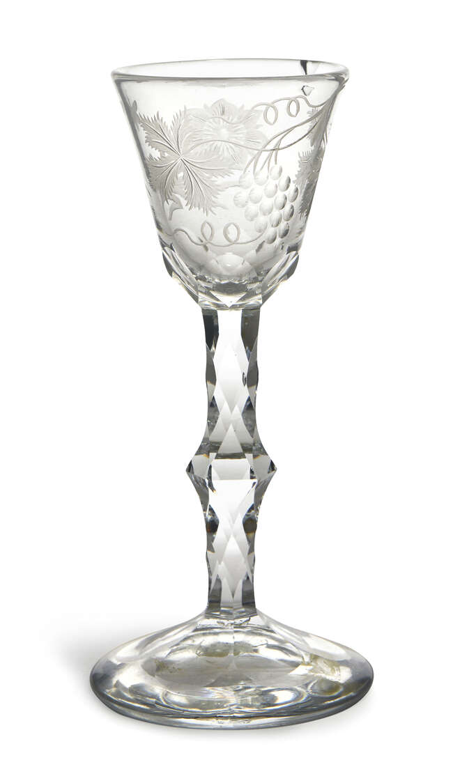 
	
		A George III cordial glass, the tapering conical bowl engraved with flowers and grapes...