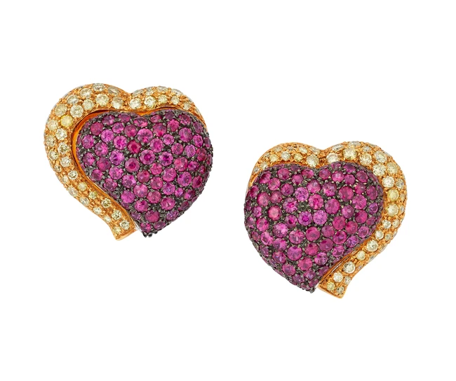 A pair of heart shaped ruby and yellow diamond earrings, designed as a pavé ruby set heart...