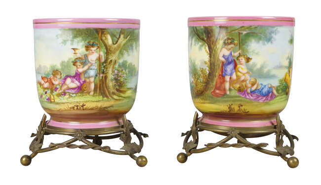 
	
		A pair of Continental porcelain ice buckets, 19th century, decorated with cherubs in...