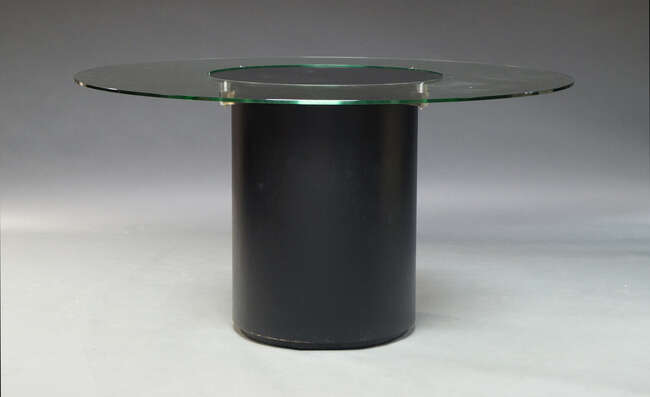 
	
		A contemporary dining table, the circular glass top with central lazy Susan, on circular...