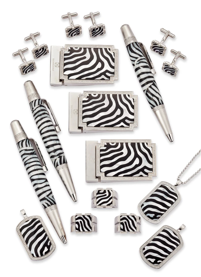 Technocrat. Three stainless steel accessories sets, the first comprising a belt buckle, pendant...