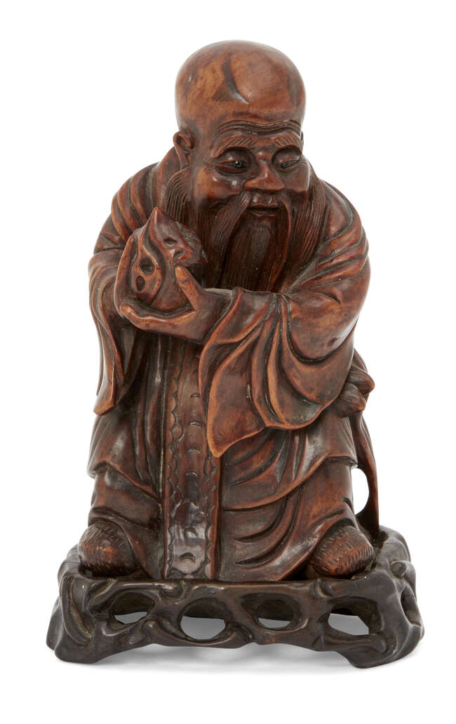 
	
		A Chinese hardwood figure of Shou Lao, 19th century, carved holding a peach and standing...