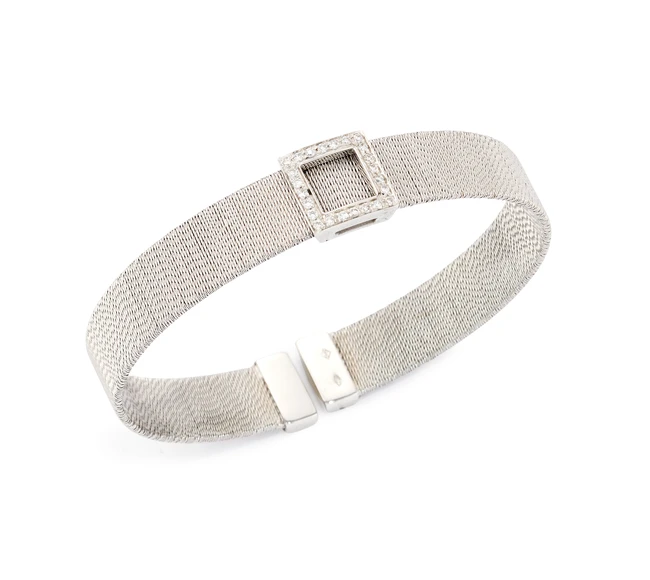 A diamond set torque bangle, with a brilliant-cut diamond set openwork buckle form panel, to...