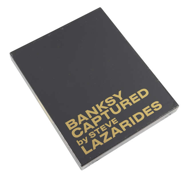
	
		After Banksy,
		British b.1974-
		 
		Banksy Captured by Steve Lazarides (Black...