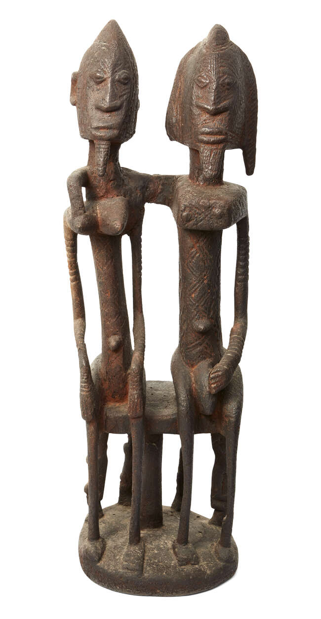 
	
		A Dogon seated couple, Mali, carved wood with encrusted patina, the two figures seated on...