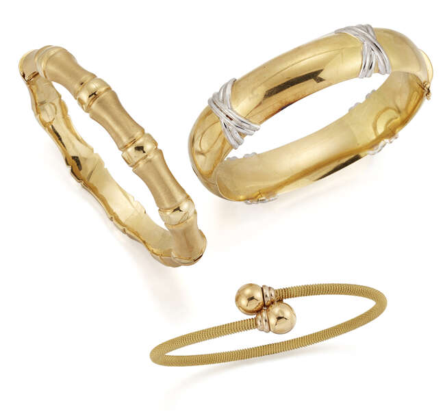 
	
		A collection of three bangles. one  of bamboo design, one of broad section with crossover...