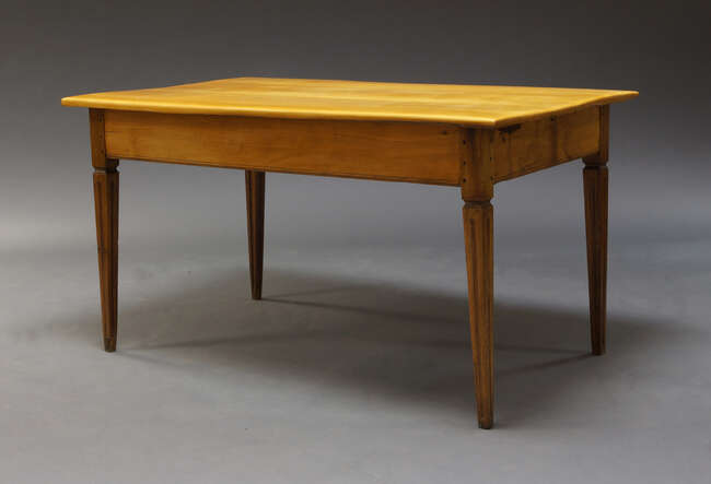
	
		A South African yellow wood dining table, second half 20th Century, the rectangular top...
