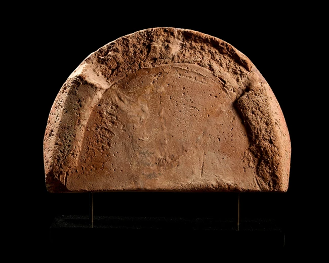 An Etruscan terracotta antefix,circa 6th Century B.C.,
the central palmette within an arched...