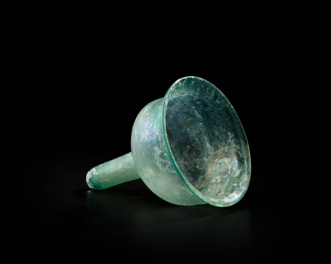 A Byzantine pale blue glass stemmed lamp insertcirca 6th Century A.D.,
With stand,
10.5cm...
