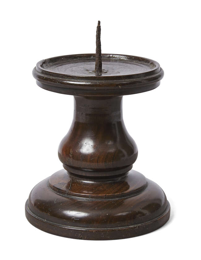 
	
		An English turned lignum vitae pricket candlestick, 17th century, the dished circular top...