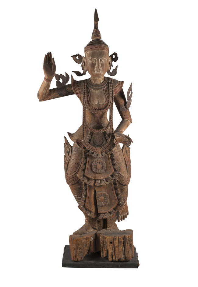 
	
		A large Thai carved wood dancing deity, 19th century, with metal flame mounts to ears and...