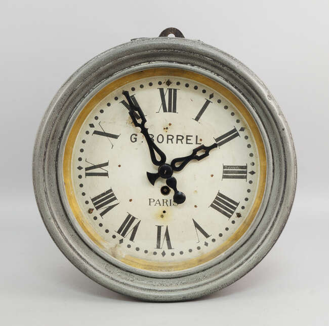 
	
		A French pressed and patinated grey metal circular wall clock by G. Borrel, Paris, the...